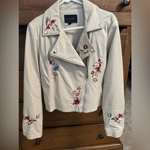 Faux leather light tan jacket with floral design.